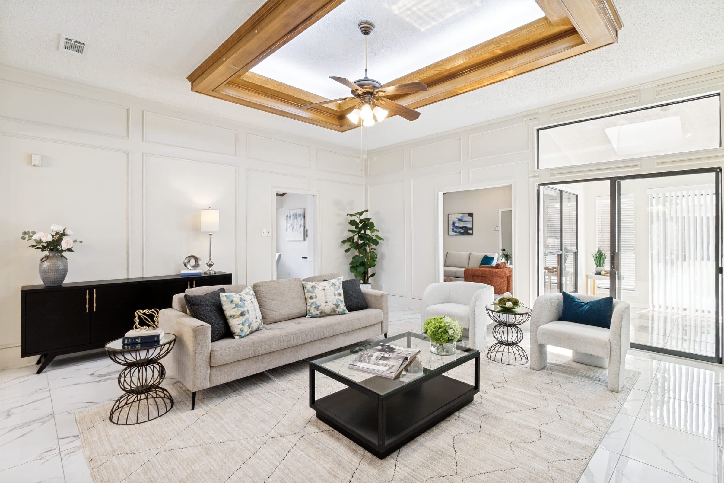Formal living room with wood-beam ceiling detail and skylight
