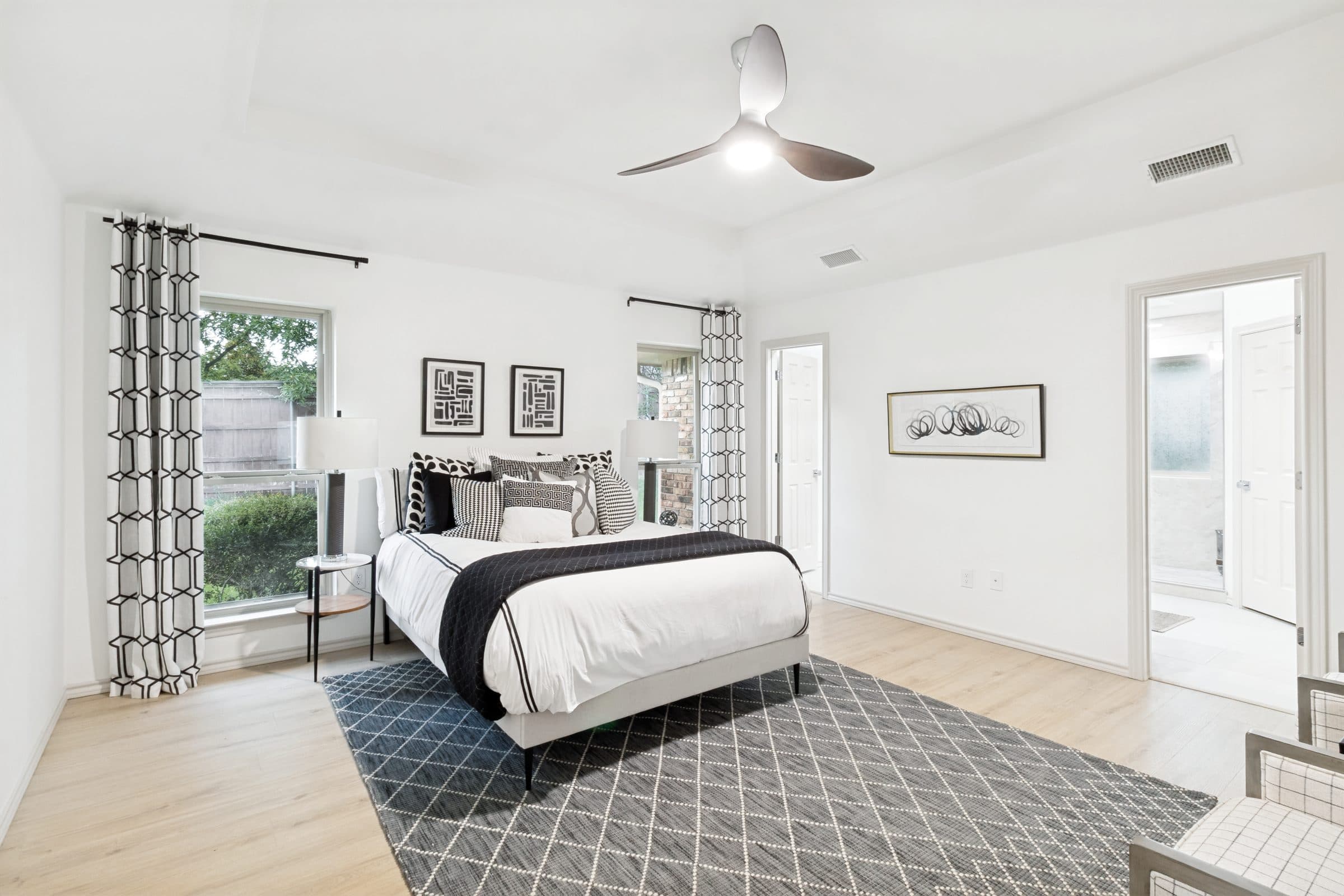 Primary bedroom suite with black and white patterned decor