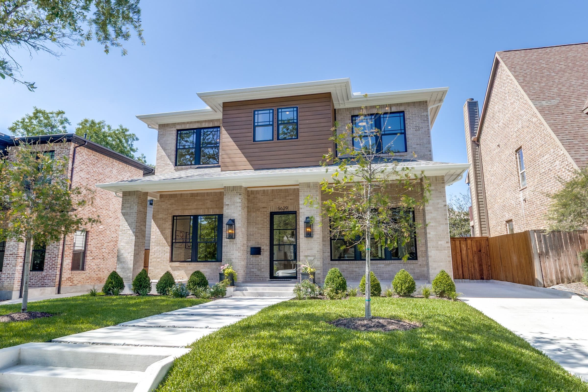 Modern two-story farmhouse-style home exterior with covered front porch