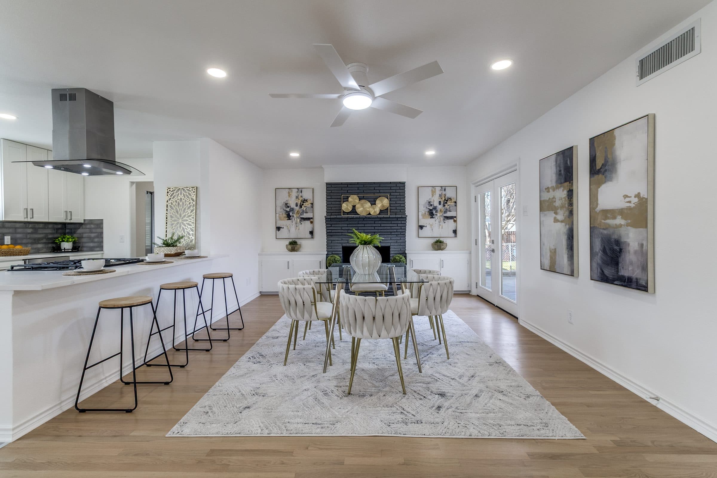 Open kitchen and dining area with painted brick fireplace