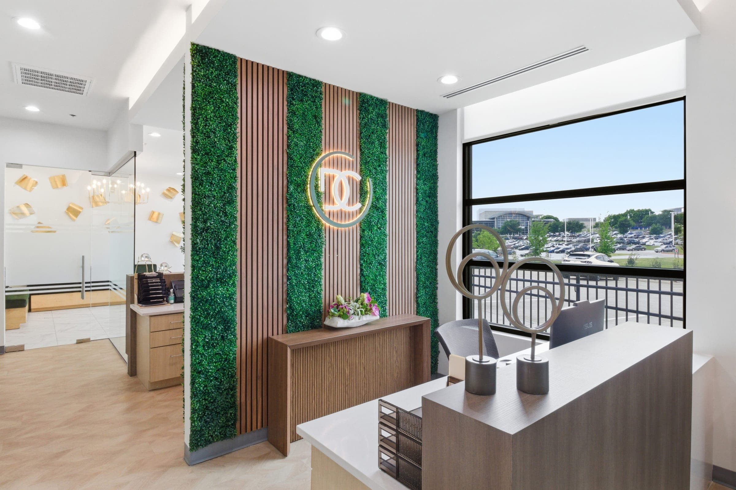 Commercial office reception area with living-wall accent and branded logo