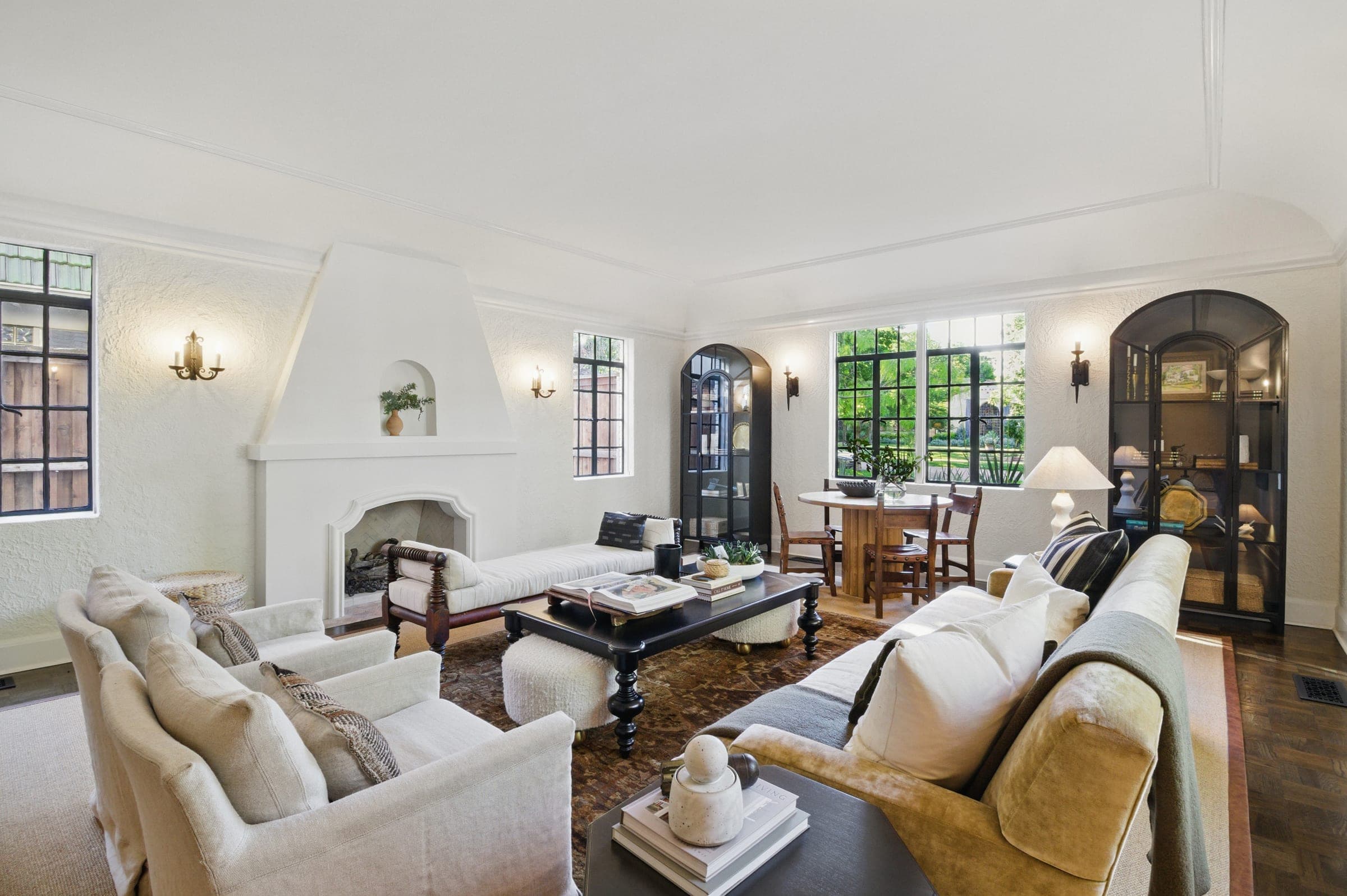 Spanish revival style living room with plaster fireplace and arched niche