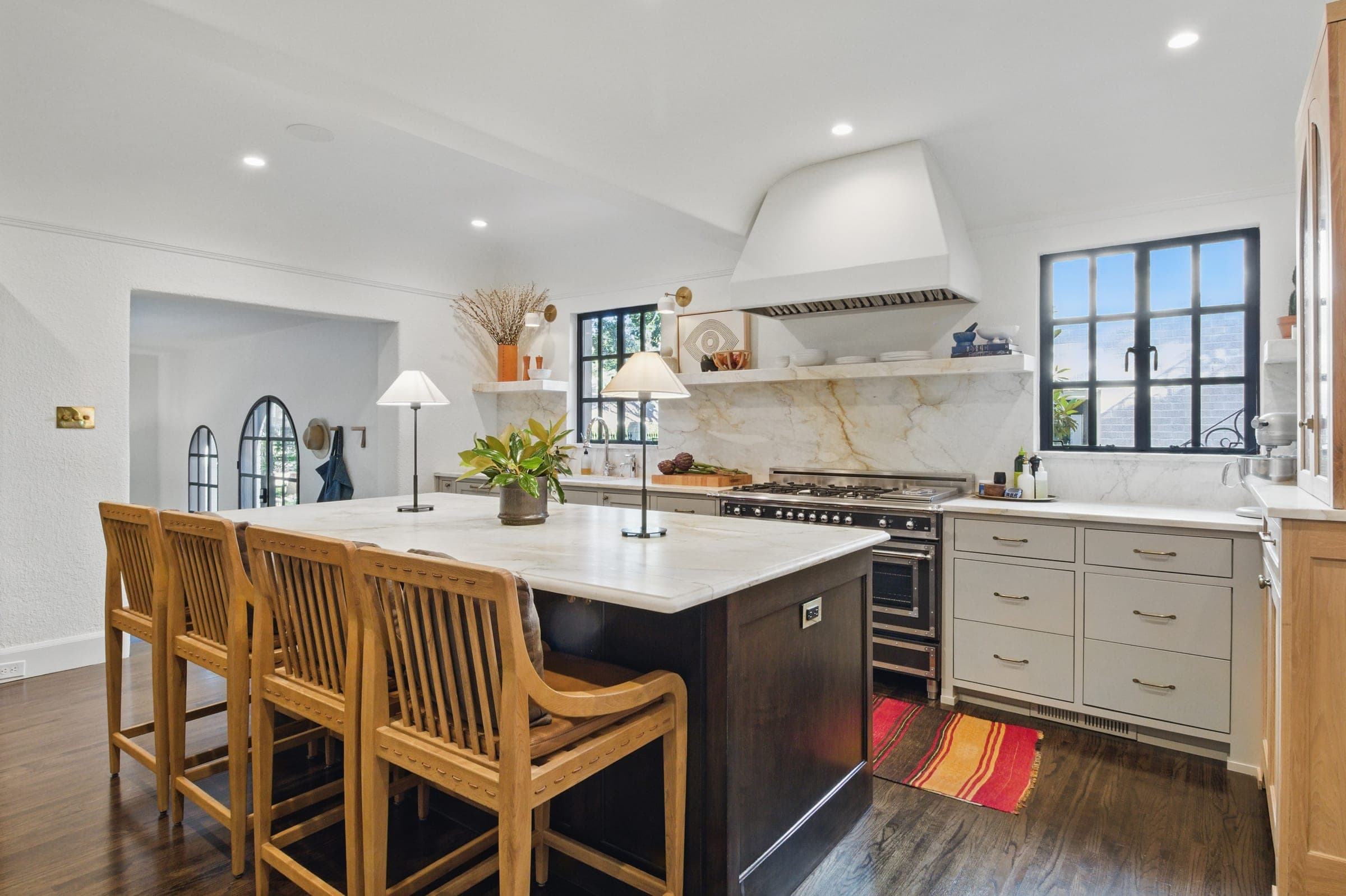Chef's kitchen with marble backsplash and professional range